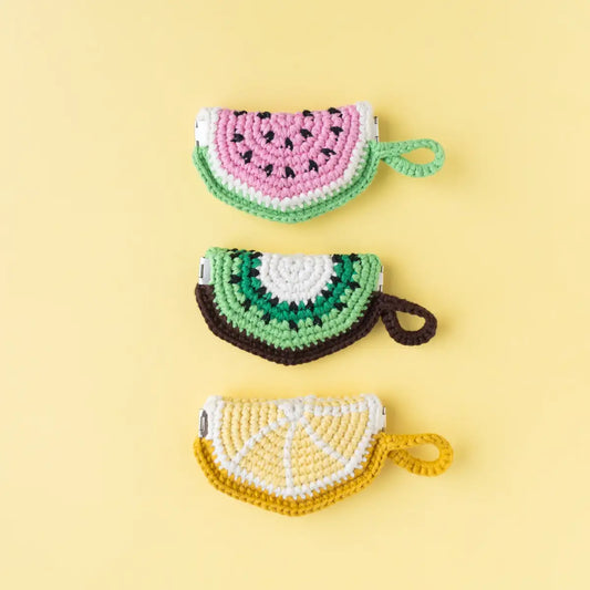 3 small crocheted fruit slice pouches with loops in the designs of a watermelon, kiwi and lime