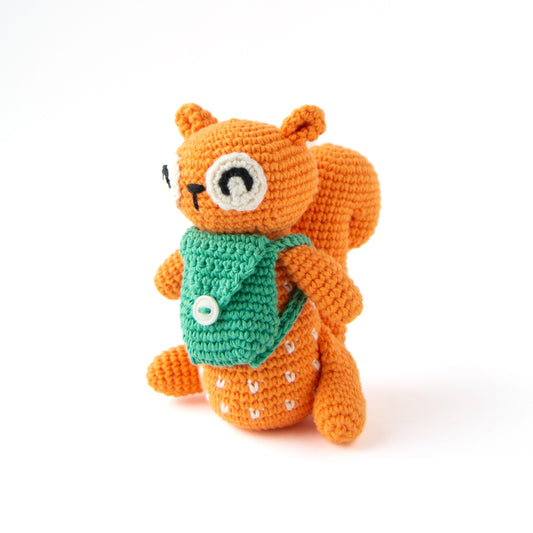 Crocheted orange squirrel with a green backpack