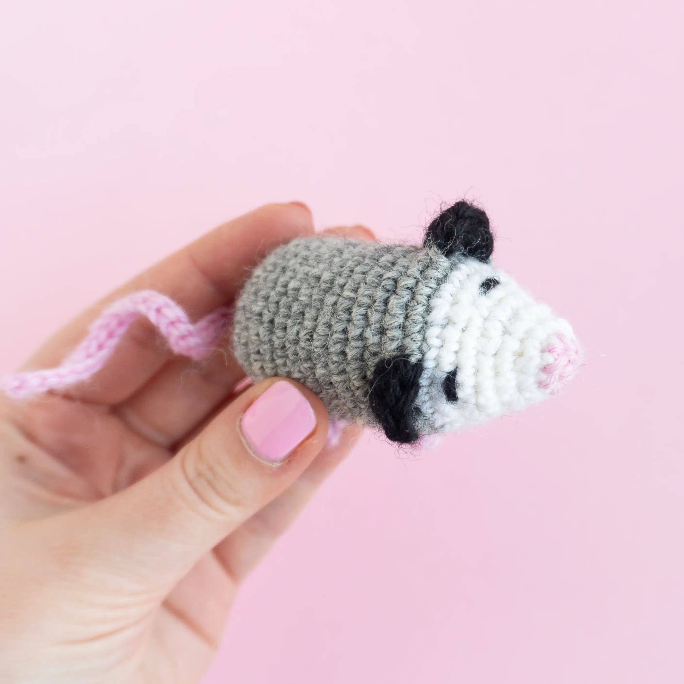 Gray crocheted opossum amigurumi